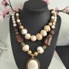COLLAR CON MEDALLÓN Y PERLAS EN TONOS BEIGES Y MARRONES M.MEDA-1 4 658097557 1112475107703059 7352061270492169312 n