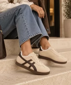 Zapatilla deportiva beige mujer con detalles laterales marrones, cordones y suela de goma baja